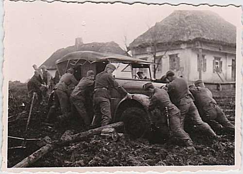 Germans pushing car in mud---Russia