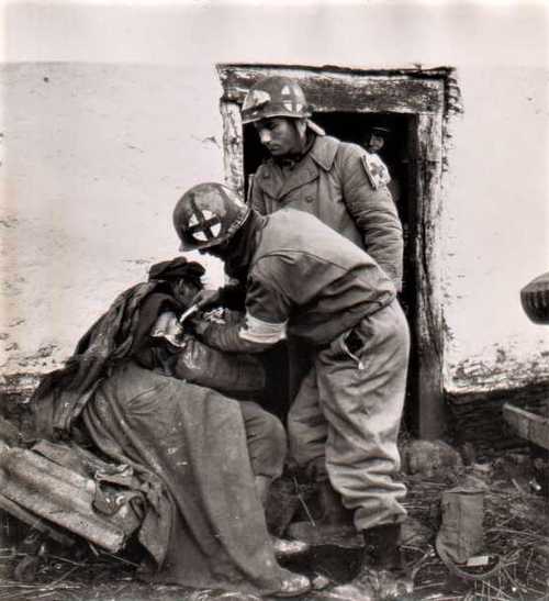 Yanks treat a wounded German soldier