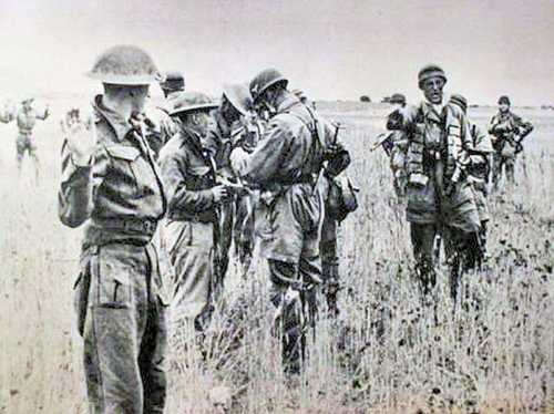 Paratroopers checking british POW's