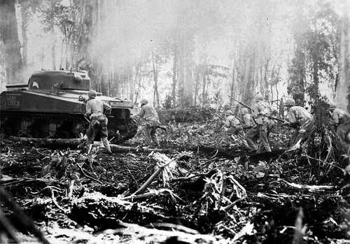 Sherman tank leads the attack