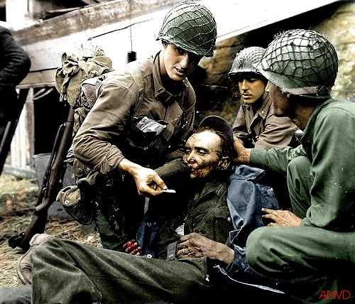 (Col.) GIs treating a wounded German,