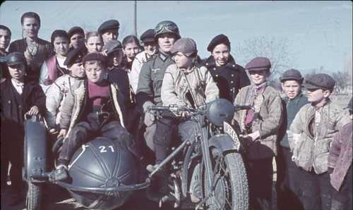 German rider poses with Bulgarian children . 1941
