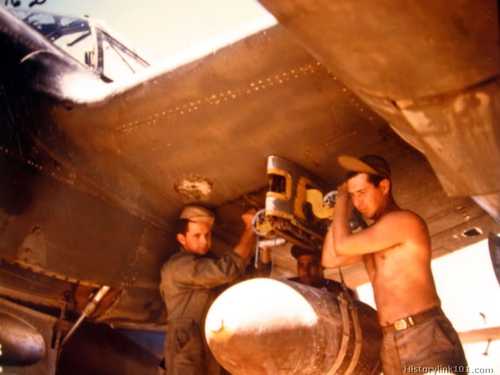 Armorers load a P-38 with a 1000 pounder