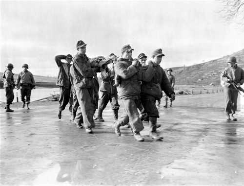 POWs with wounded comrade