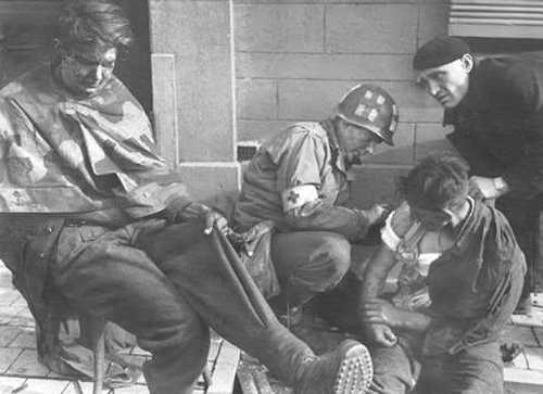 Medic tends to wounded German PoW