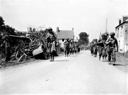Infantry moves on in a small village
