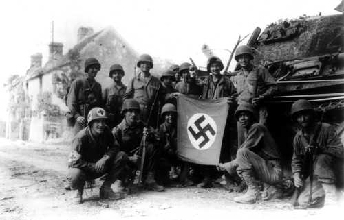 Soldiers with captured swastika