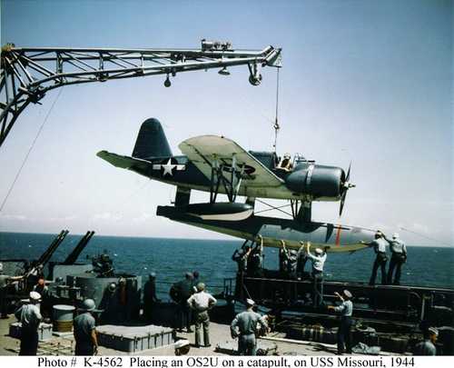 Placing an OS2U on a catapult, on USS Missouri
