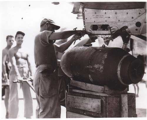 Ground crew hang a 1000 pound bomb