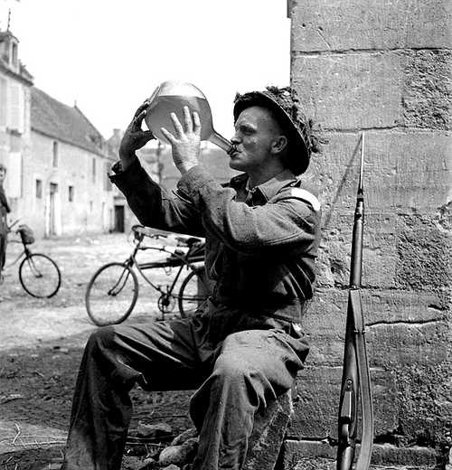 A Young Canadian soldier cracks a bottle of wine