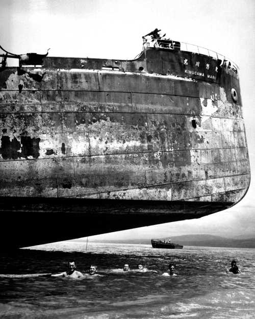 Coast Guardsmen Swim under Japanese Wreck