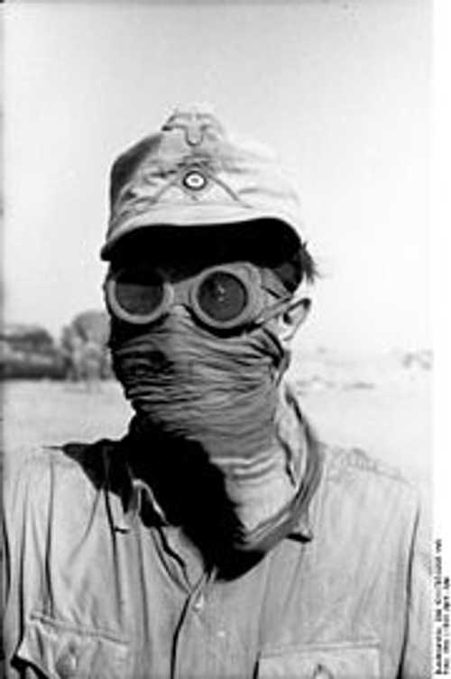 German soldier protecting face from sand