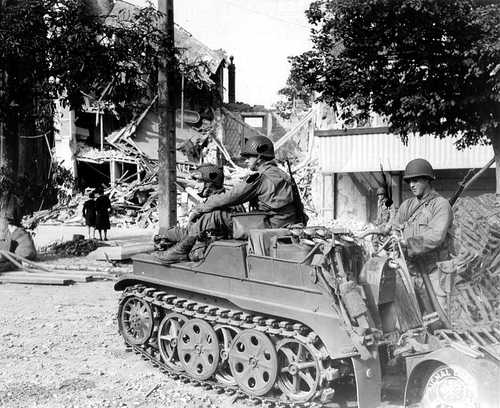 GIs with a captured tracked vehicle