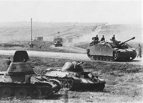A StuG rides past Soviet armor