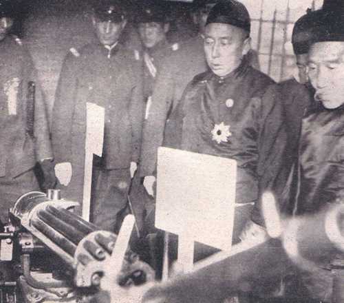 Prince Demchugdongrub inspects a weapon