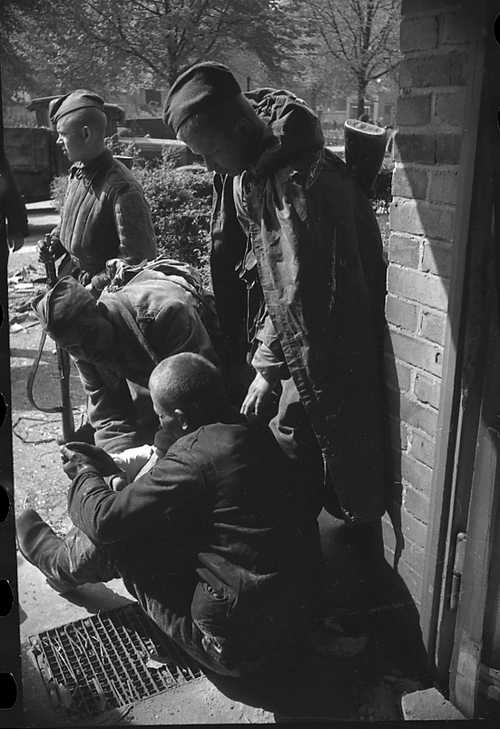 First aid to the wounded in a street battle.