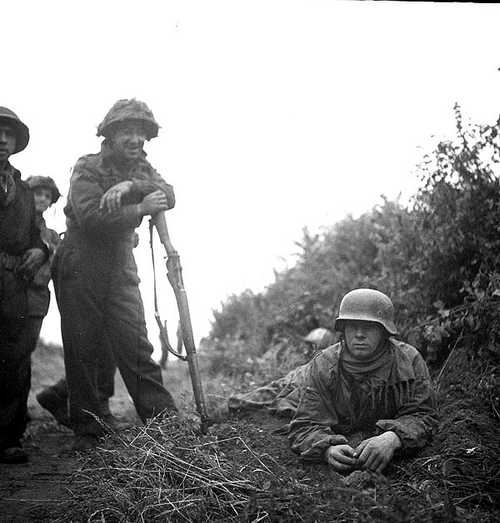 Private Marcoux proudly displays his prisoner