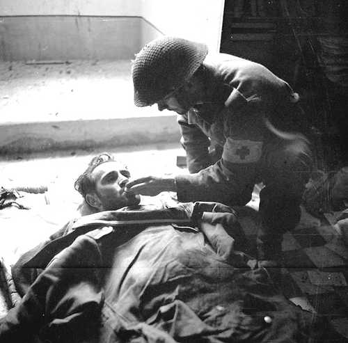 Canadian Medic gives water to injured German 