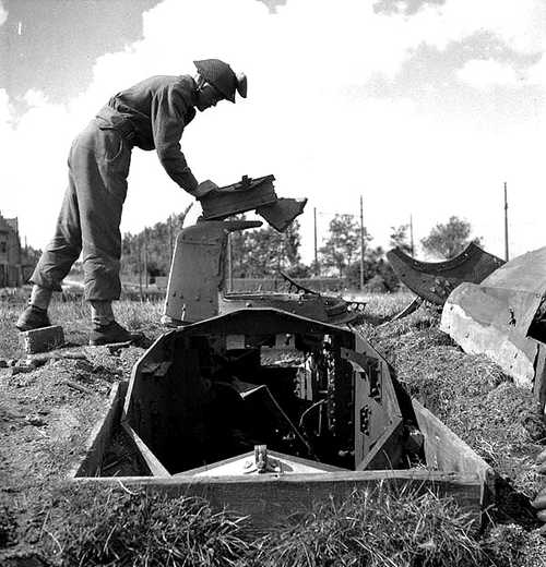 A Canadian soldier examines a German pill box