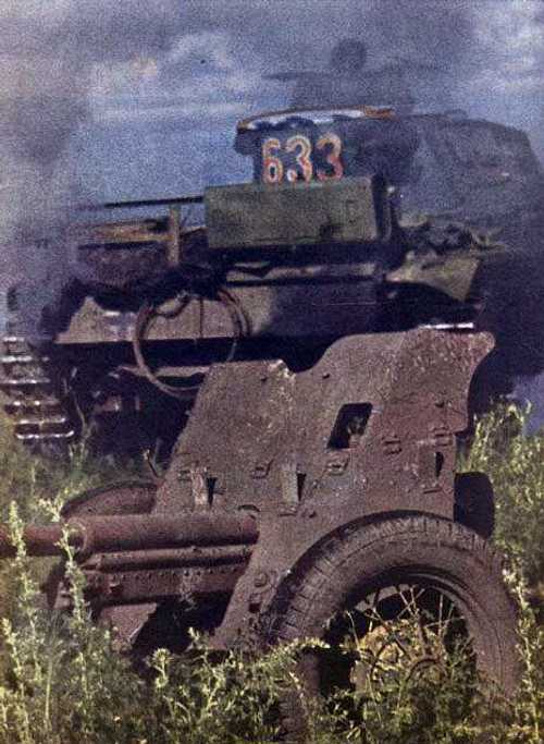 Panzer passing antitank gun.