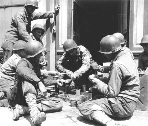 Eight soldiers eat as a group