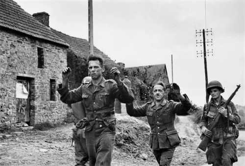 POWs are escorted to the rear