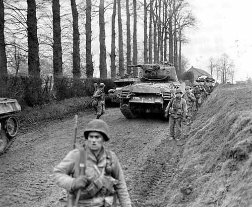 Infantry and tanks on a dirt road