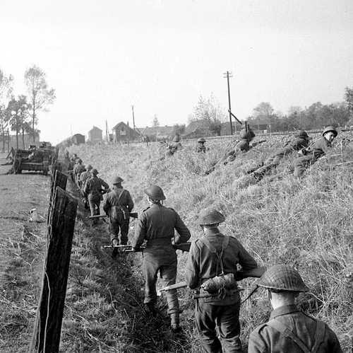 Infantry advance along an embankment