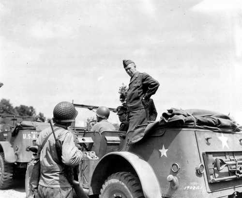 The General stops to talk to a serviceman