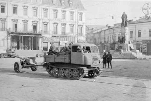 Military tractor tows a gun