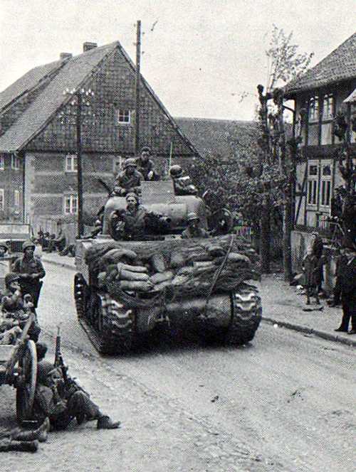 Troops resting, locals look on