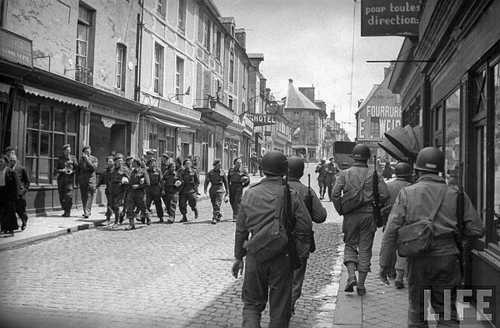 Allied soldiers pass one another