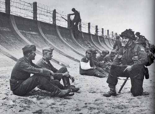 A Canadian Soldier guards Germans
