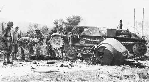 Examining a destroyed Japanese tank
