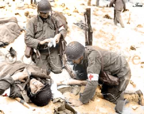 Medics helping injured medic on beach