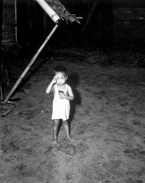 Little Filipino Boy Salutes at Passing Troops