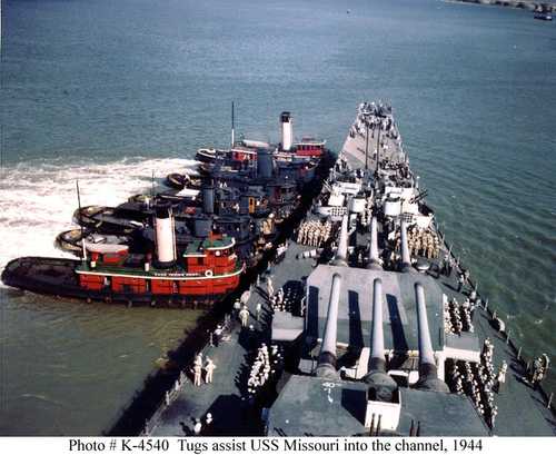 Tugs assist USS Missouri into the channel