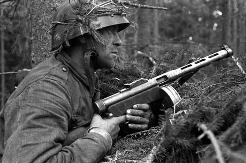 Submachine gunner in the woods